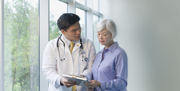 Doctor reviewing health record with patient